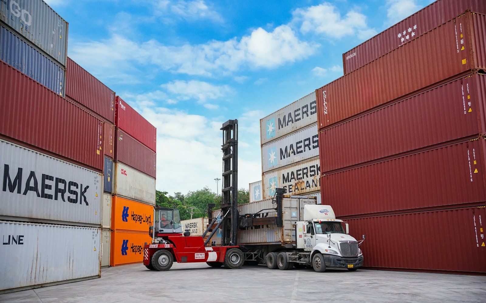 A logistics warehouse with trucks loading cargo